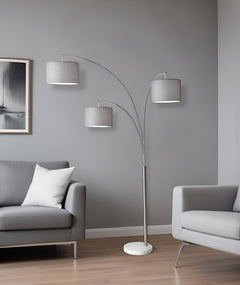 74" Brass Three Light Arc Floor Lamp With Off White Fabric Drum Shade