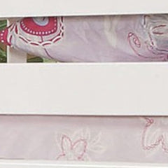 White Twin Over Twin Bunk Bed featuring a slatted design and soft bedding with floral patterns. Ideal for space-saving.