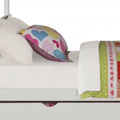 White twin over full solid wood bunk bed with stairs, trundle, and storage, featuring colorful bedding and decorative pillows