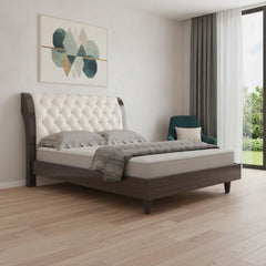 Solid wood king bed with tufted beige faux leather upholstery and nailhead trim, featuring a sleek design and modern aestheti