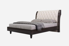 Solid wood king bed with tufted beige faux leather upholstery and nailhead trim, featuring a sleek design and dark wood finis