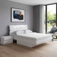 Modern Queen White High Gloss Bed by Wellnesslifeclub74 in a stylish bedroom setting with a nightstand and artwork.