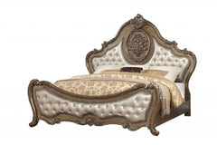 Queen Tufted Bronze Upholstered Faux Leather Bed with Nailhead Trim featuring ornate detailing and a luxurious design.