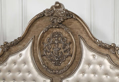 Queen tufted bronze upholstered faux leather bed featuring intricate nailhead trim and ornate detailing on the headboard.