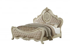 Antiqued white solid wood tufted upholstered linen bed frame with ornate detailing and plush cushioning.