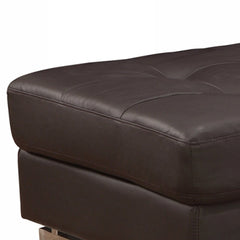 63" Brown and Silver Faux Leather Tufted Ottoman with a smooth, padded surface and sleek silver base.
