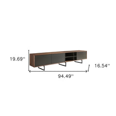 94" gray solid and manufactured wood TV stand with enclosed and open storage, featuring sleek legs and modern design.
