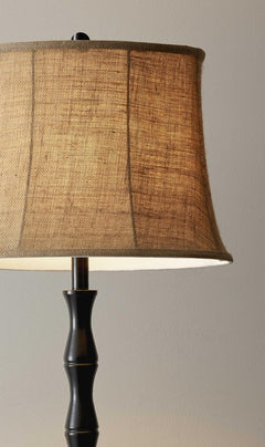 62" brown and black floor lamp featuring a beige burlap shade, showcasing a stylish and modern design.