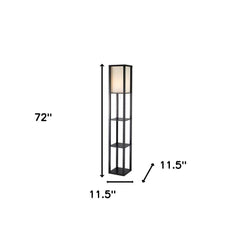 72" black and white solid wood column lamp with a white cotton shade and three open shelves for storage or display.