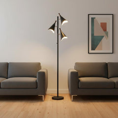 68" Black Three Light Tree Floor Lamp with black metal cone shades, positioned between two gray sofas in a modern living room