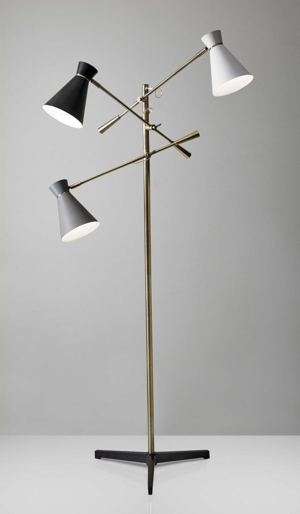 Brass novelty floor lamp with a black metal base and black and white iron cone shade.
