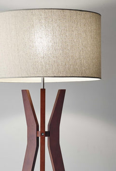 60" brown and white solid wood tripod floor lamp with a white fabric drum shade, featuring a modern design and sleek lines.