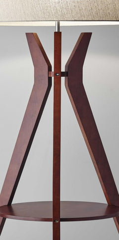 Brown and white solid wood tripod floor lamp with a white fabric drum shade and a circular wooden base.