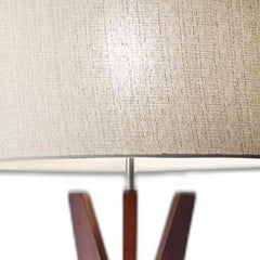 Solid wood tripod floor lamp featuring a white fabric drum shade, showcasing a textured finish and elegant design.