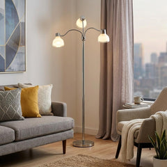 69" Silver Three Light Tree Floor Lamp with white plastic bowl shades, featuring a modern design in a cozy living room settin