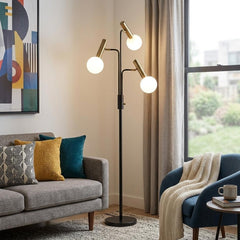 70" Black and Bronze Three Light LED Tree Floor Lamp with White globes, set in a cozy living room with modern decor.