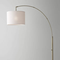 74" Brass Metal Arc Floor Lamp with off-white linen drum shade, featuring a sleek curved design for modern decor.
