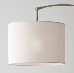 74" Brass Metal Arc Floor Lamp with Off White Linen Drum Shade, featuring a sleek design and soft lighting.