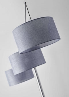 Silver three light tree floor lamp featuring gray linen drum shades, elegantly designed for modern decor.