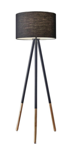 Black metal tripod floor lamp with a black fabric drum shade and wooden accents on the legs. Modern and stylish design.