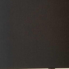 Black metal tripod floor lamp with a black fabric drum shade, featuring a sleek and modern design.