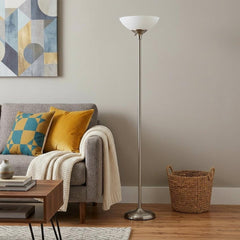 71" Silver Metal Torchiere Floor Lamp with White Bowl Shade beside a gray sofa with colorful pillows and a woven basket.