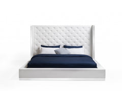 White tufted faux leather upholstered king bed frame with a tall headboard and a sleek, modern design.