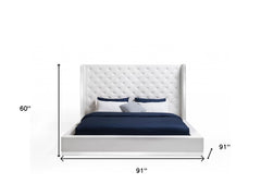 White tufted faux leather upholstered king bed frame with a tall headboard and dimensions of 91" x 91" x 60".