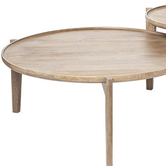 Set of two brown solid wood round nested coffee tables with a smooth surface and slender legs, showcasing a minimalist design