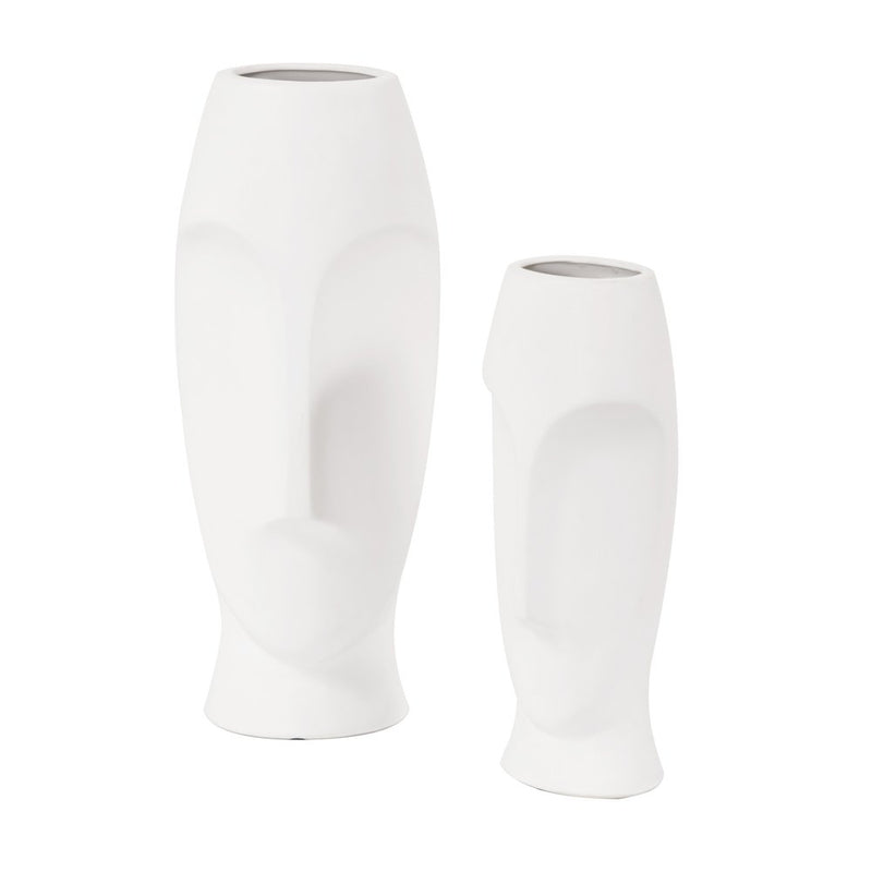 Set of two ceramic white cylinder table vases with abstract face designs, varying in height and smooth matte finish.