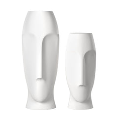 Set of two ceramic white cylinder table vases with abstract face designs, featuring smooth finishes and modern shapes.