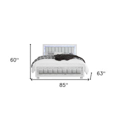 White solid wood and faux leather lighted king bed frame with a modern design, featuring a padded headboard and storage.