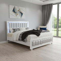 White solid wood and faux leather lighted king bed frame with a modern design, featuring a padded headboard and cozy bedding.