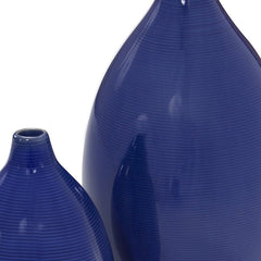 Set of two cobalt ceramic round table vases featuring a smooth, glossy finish and subtle striped texture.