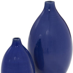Set of two cobalt ceramic round table vases in varying sizes, featuring a smooth, glossy finish and subtle ribbed texture.