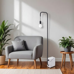 59" Black and White Steel LED Floor Lamp with a marble base, beside a gray sofa and plants in a modern living room setting.
