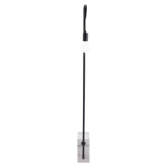 59" Black and White Steel LED Floor Lamp with a sleek black pole and a round white bulb on a clear base.