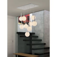 Dimmable ceiling light with nine white shaded globes hanging from a sleek metal fixture, set in a modern interior.