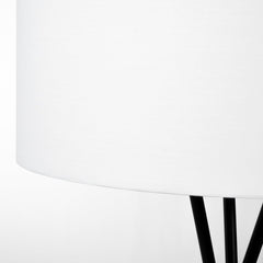 66" black tripod floor lamp featuring a white fabric drum shade, showcasing a modern and minimalist design.