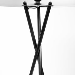 Black tripod floor lamp with a white fabric drum shade, featuring a sleek, modern design and sturdy crossed legs.