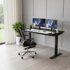 Adjustable Black Stainless Steel Rolling Computer Desk with dual monitors, ergonomic chair, and potted plant in a modern work