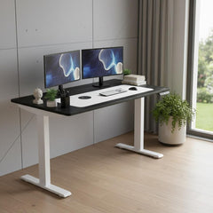 Adjustable black and white wood and stainless steel rolling computer desk with dual monitors, keyboard, and potted plant.