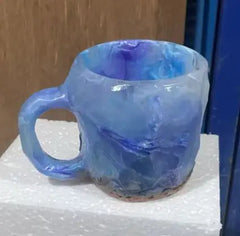 Decorative resin crystal mug displayed on open kitchen shelf as home décor accent piece
