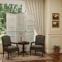 67" White Solid Wood Folding Three Panel Screen Room Divider in a cozy room setting with two chairs and a table.