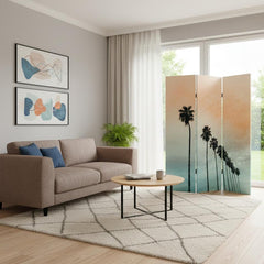 Light green 72" folding three-panel screen room divider featuring palm trees, set in a modern living room with a sofa and cof