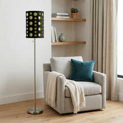 66" Steel Novelty Floor Lamp with a black and green drum shade, placed next to a cozy armchair with a teal pillow.