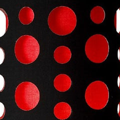 Close-up of a black and red drum shade featuring circular cutouts, part of a 66" steel novelty floor lamp by Wellnesslifeclub
