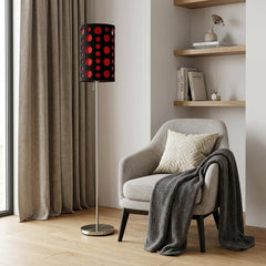 66" Steel Novelty Floor Lamp with black and red drum shade beside a cozy chair and a shelf with decor items.