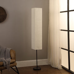 63" black and off-white column floor lamp with a textured off-white rectangular shade, set against a neutral wall.