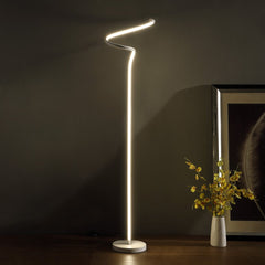 51" White LED Novelty Floor Lamp with a sleek, curved design, illuminating a dark space with a modern aesthetic.